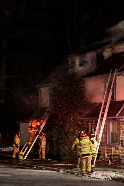 Radnor firefighters placing ladders to access the building and to provide safety for the ffighters inside.